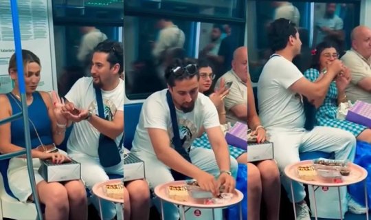 Metroda süfrə açıb insanlara "zorla" yemək yedirtdi - VİDEO